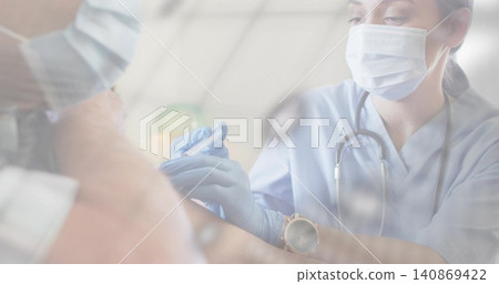 Preparing clinician in scrubs with surgical mask and blue gloves, administering syringe in clinic Preparing clinician in scrubs with surgical mask and blue gloves, administering syringe in clinic 140869422