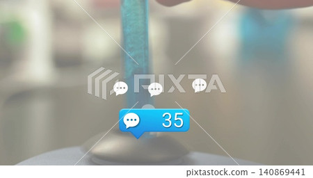 Displaying blue chat notification bubble showing 35 with clear rod and suction base on desk, bokeh 140869441