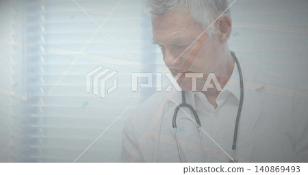 Standing senior doctor reviewing chart at office window, in white lab coat, stethoscope, copy space Standing senior doctor reviewing chart at office window, in white lab coat, stethoscope, copy space 140869493