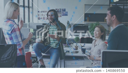 Talking four-person team in casual shirts and jeans at open office with screens and sticky notes Talking four-person team in casual shirts and jeans at open office with screens and sticky notes 140869550