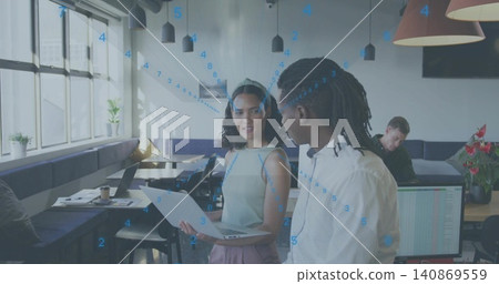 Talking woman wearing sleeveless top and headband presenting laptop and paper in coworking space Talking woman wearing sleeveless top and headband presenting laptop and paper in coworking space 140869559