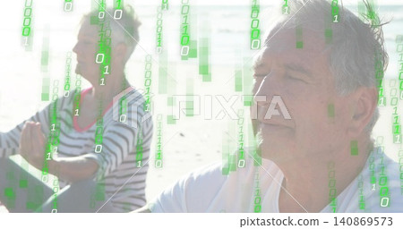 Sitting senior man wearing white tee beside partner in striped top on sand, green binary overlay Sitting senior man wearing white tee beside partner in striped top on sand, green binary overlay 140869573