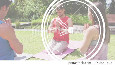 Kneeling central man wearing red sleeveless top pressing palms on pink mat near pond, clock overlay Kneeling central man wearing red sleeveless top pressing palms on pink mat near pond, clock overlay 140869597
