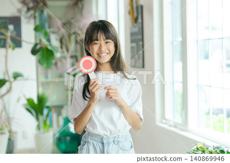 A girl holding a Maru plate A girl holding a Maru plate 140869946