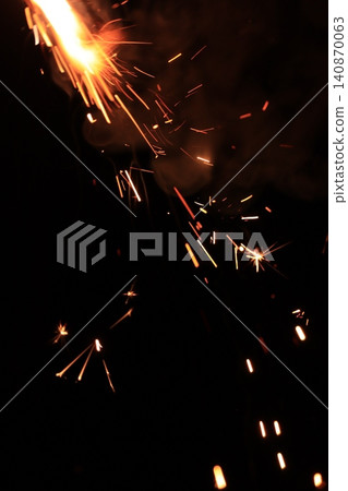 Fireworks that draw a beautiful parabola in orange color Fireworks that draw a beautiful parabola in orange color 140870063