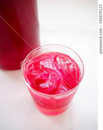 Red perilla juice in a glass and red perilla syrup in a bottle Red perilla juice in a glass and red perilla syrup in a bottle 140870123