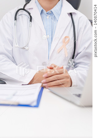 doctor using laptop and report notes on notebook. peach ribbon concept of September Uterine Cancer Awareness month, Endometrial, Gynecologic, Uterus and Ovaries, Endometriosis, June Vaginal cancer doctor using laptop and report notes on notebook. peach ribbon concept of September Uterine Cancer Awareness month, Endometrial, Gynecologic, Uterus and Ovaries, Endometriosis, June Vaginal cancer 140870414