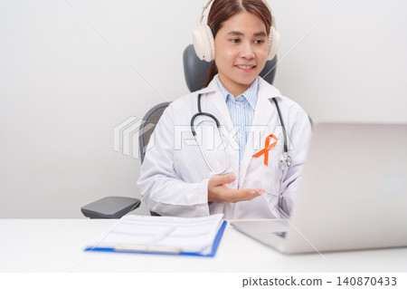 Professional doctor using laptop with orange ribbon for telehealth online meeting about February World Cancer Day, September Leukemia, March Kidney, August Appendix cancer, November CRPS and COPD Professional doctor using laptop with orange ribbon for telehealth online meeting about February World Cancer Day, September Leukemia, March Kidney, August Appendix cancer, November CRPS and COPD 140870433