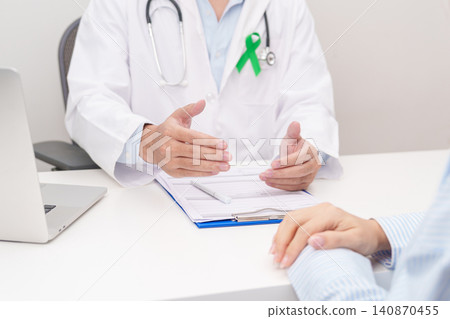 Doctor and patient having a medical consultation for lime Green Ribbon for concept of May Celiac Awareness month, Lyme disease, September Lymphoma, Mental Health Awareness month and Liver cancer Doctor and patient having a medical consultation for lime Green Ribbon for concept of May Celiac Awareness month, Lyme disease, September Lymphoma, Mental Health Awareness month and Liver cancer 140870455