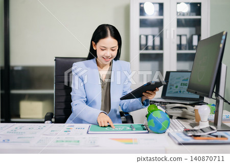 Asian businesswoman presenting Net Zero and ESG strategy in a modern office, promoting sustainability, carbon reduction, renewable energy and green business innovation Asian businesswoman presenting Net Zero and ESG strategy in a modern office, promoting sustainability, carbon reduction, renewable energy and green business innovation 140870711