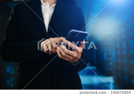 IT professional using tablet in data center server room, managing cloud network infrastructure, cybersecurity systems and enterprise digital technology operations. IT professional using tablet in data center server room, managing cloud network infrastructure, cybersecurity systems and enterprise digital technology operations. 140870884