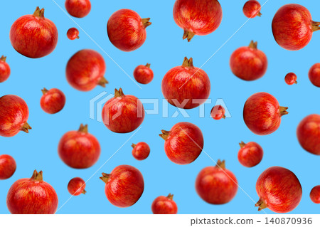 Red pomegranates dot a bright blue background Red pomegranates dot a bright blue background 140870936