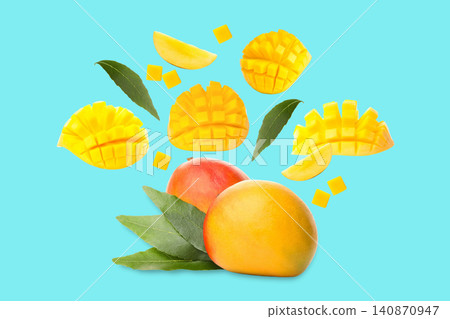 Fresh mangoes display rich colors alongside beautifully sliced pieces 140870947