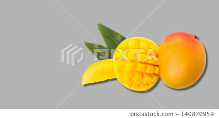 Ripe mango sits next to a sliced piece displaying rich yellow flesh. Sweet fruit concept Ripe mango sits next to a sliced piece displaying rich yellow flesh. Sweet fruit concept 140870959