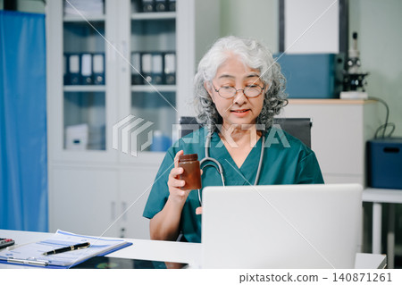 Doctor in online consultation discussing patient treatment via laptop, highlighting telemedicine, healthcare communication, diagnosis Doctor in online consultation discussing patient treatment via laptop, highlighting telemedicine, healthcare communication, diagnosis 140871261