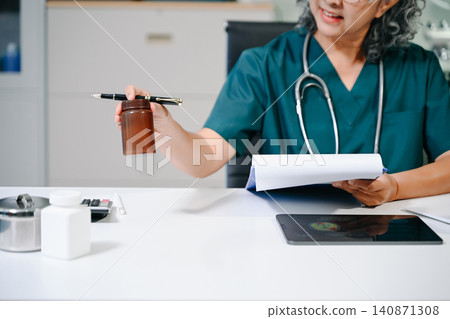 Senior doctor working on laptop in clinic, showcasing healthcare, medical technology, patient care, telemedicine, and professional expertise Senior doctor working on laptop in clinic, showcasing healthcare, medical technology, patient care, telemedicine, and professional expertise 140871308
