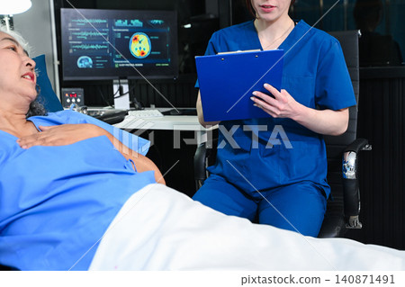 professional nurse records medical data on a clipboard while consulting with an elderly patient in a hospital bed, representing healthcare administration and geriatric care. professional nurse records medical data on a clipboard while consulting with an elderly patient in a hospital bed, representing healthcare administration and geriatric care. 140871491