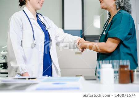 Doctor handshake and partnership in healthcare, medicine or trust for collaboration, unity or support.Team of medical experts shaking hands in teamwork for or success in clinic or hospital Doctor handshake and partnership in healthcare, medicine or trust for collaboration, unity or support.Team of medical experts shaking hands in teamwork for or success in clinic or hospital 140871574