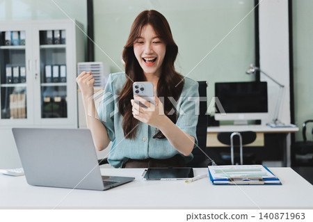 Businesswoman working with tablet and financial reports in modern office Businesswoman working with tablet and financial reports in modern office 140871963