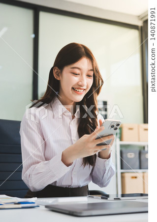 Young businesswoman professional employee using pc doing online banking analysing at workplace. Asian middle-aged business woman working on laptop computer in office, taking notes. Banner, copy space Young businesswoman professional employee using pc doing online banking analysing at workplace. Asian middle-aged business woman working on laptop computer in office, taking notes. Banner, copy space 140871991