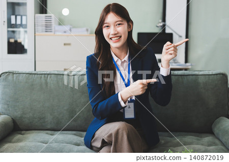 Asian businesswoman sitting at work using laptop talking and consulting in office Asian businesswoman sitting at work using laptop talking and consulting in office 140872019