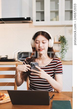 Asian woman using computer remote for business studying, watching online virtual webinar training meeting, video call. asian business woman talking on laptop in home office. Banner, copy space 140872033