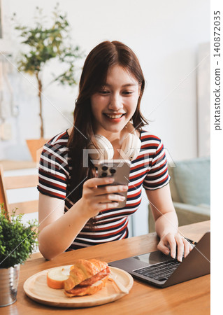 Asian woman using computer remote for business studying, watching online virtual webinar training meeting, video call. asian business woman talking on laptop in home office. Banner, copy space Asian woman using computer remote for business studying, watching online virtual webinar training meeting, video call. asian business woman talking on laptop in home office. Banner, copy space 140872035