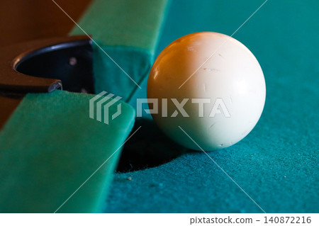 White Cue Ball Near Pocket On Blue Pool Table White Cue Ball Near Pocket On Blue Pool Table 140872216