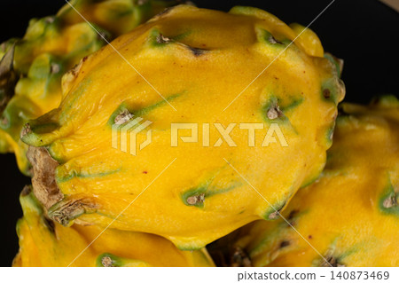 Close-up texture of yellow dragon fruit skin on black background 140873469