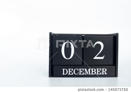Black flip calendar displaying December 02 with bold white numerals on a minimalist black calendar. Black flip calendar displaying December 02 with bold white numerals on a minimalist black calendar. 140873788