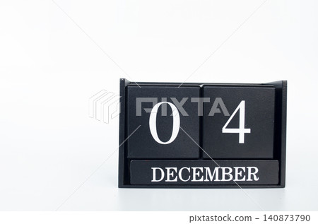 Black flip calendar displaying December 04 with bold white numerals on a minimalist black calendar. Black flip calendar displaying December 04 with bold white numerals on a minimalist black calendar. 140873790