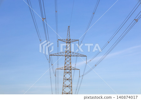 High voltage power transmission tower against blue sky High voltage power transmission tower against blue sky 140874017