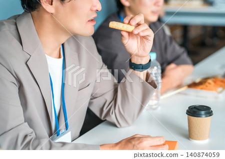 Businessmen (boss and subordinates) having lunch in a company office Businessmen (boss and subordinates) having lunch in a company office 140874059