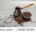 Cezve and a stone bowl with roasted coffee beans. 140874081