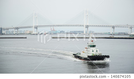 A view of the Yokohama Bay Bridge and port workboats. A view of the Yokohama Bay Bridge and port workboats. 140874105