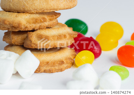 Danish butter cookies, colorful candies, and marshmallows on a white background. Close-up. 140874274