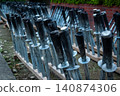 Metal torches lined up against a dark background 140874306