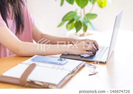 Women handling personal computers Women handling personal computers 140874720