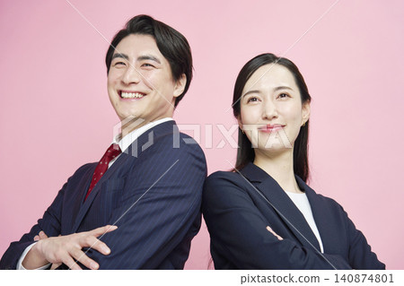 Portraits of a businessman and businesswoman against a pink background. Portraits of a businessman and businesswoman against a pink background. 140874801