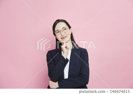 A smiling businesswoman on a pink background. A smiling businesswoman on a pink background. 140874815