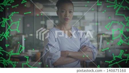 Standing woman crossing arms facing camera in office wearing striped blouse with neon overlay Standing woman crossing arms facing camera in office wearing striped blouse with neon overlay 140875168