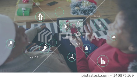 Holding tablet, women wearing cream hat and red sweater sitting in living room, viewing AR icons Holding tablet, women wearing cream hat and red sweater sitting in living room, viewing AR icons 140875169