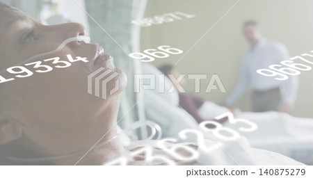 Receiving oxygen via nasal cannula, male patient lying on hospital bed wearing gown, data overlays Receiving oxygen via nasal cannula, male patient lying on hospital bed wearing gown, data overlays 140875279