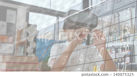 Exploring schoolboy viewing virtual stock grid in classroom, wearing white shirt and headset Exploring schoolboy viewing virtual stock grid in classroom, wearing white shirt and headset 140875325