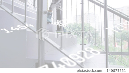 Ascending senior woman carrying briefcase on modern stairs near glass, showing digits, copy space Ascending senior woman carrying briefcase on modern stairs near glass, showing digits, copy space 140875331