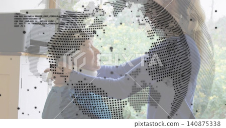 Adjusting daughter in blue sweater helping mother by window with scarf and dotted globe overlay Adjusting daughter in blue sweater helping mother by window with scarf and dotted globe overlay 140875338