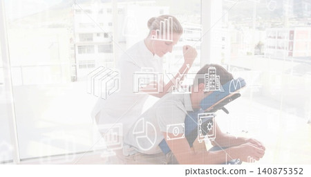 Pressing therapist white top pressing client's back on blue face cradle chair in spa with overlays 140875352