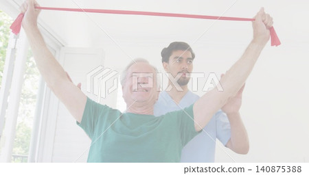 Raising senior in green tee pulling red band up in clinic, assistant in light-blue scrubs guiding Raising senior in green tee pulling red band up in clinic, assistant in light-blue scrubs guiding 140875388