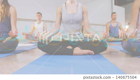 Breathing woman in gray tank black leggings sitting in studio with blue mats barre waveform Breathing woman in gray tank black leggings sitting in studio with blue mats barre waveform 140875504