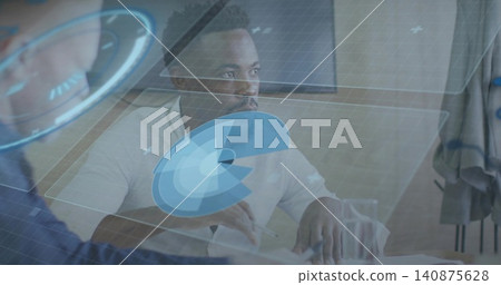 Holding pen, man in white shirt studying documents at conference table with holographic overlays 140875628